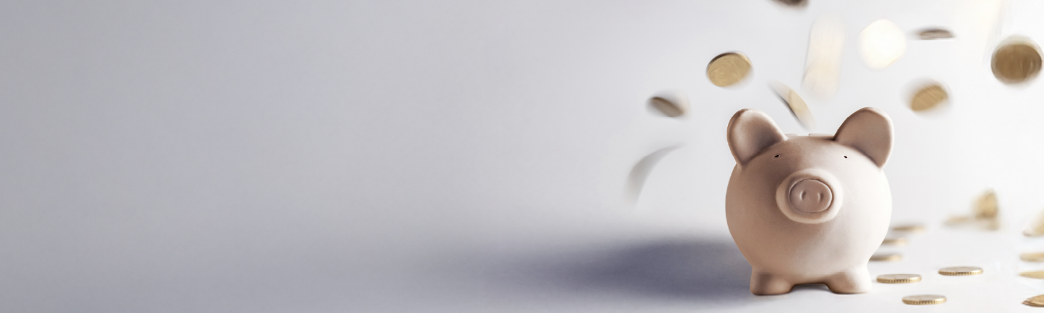 Piggybank with coins beside it